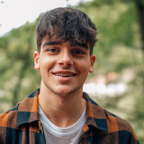 teenage boy in black, hooded sweatshirt